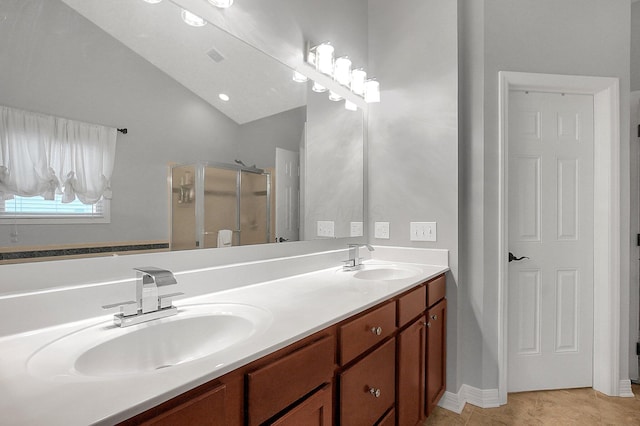 full bathroom with a sink, tile patterned floors, a shower stall, and double vanity