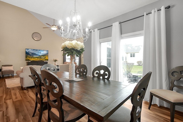 dining room with light wood-style floors and a notable chandelier