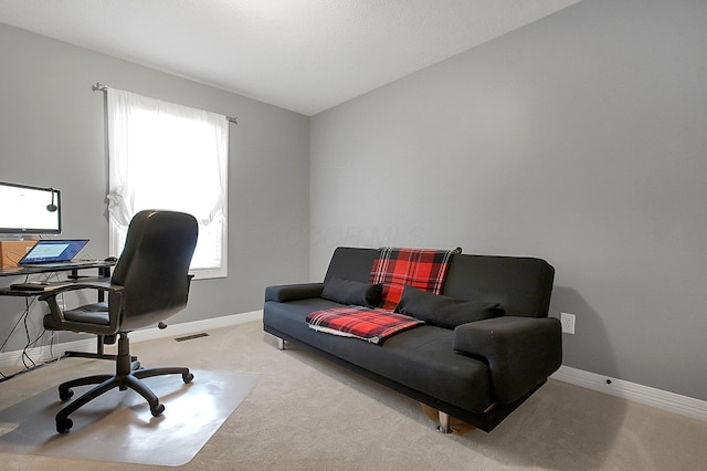 carpeted office with visible vents and baseboards