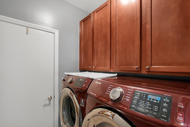 laundry room with cabinet space and separate washer and dryer
