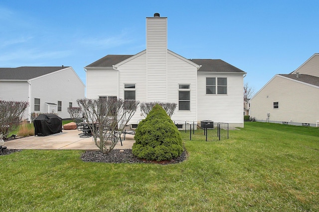 back of house with a chimney, a lawn, central air condition unit, fence, and a patio