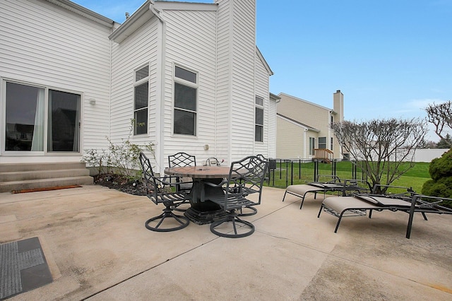 view of patio with entry steps and outdoor dining area