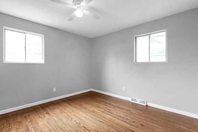 542 E Franklin St, Circleville, OH 43113 - unfurnished room with ceiling fan, baseboards, visible vents, and wood finished floors