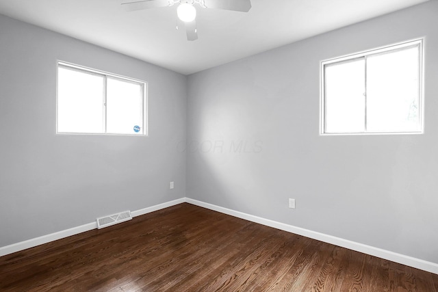 542 E Franklin St, Circleville, OH 43113 - spare room featuring a ceiling fan, baseboards, visible vents, and dark wood finished floors