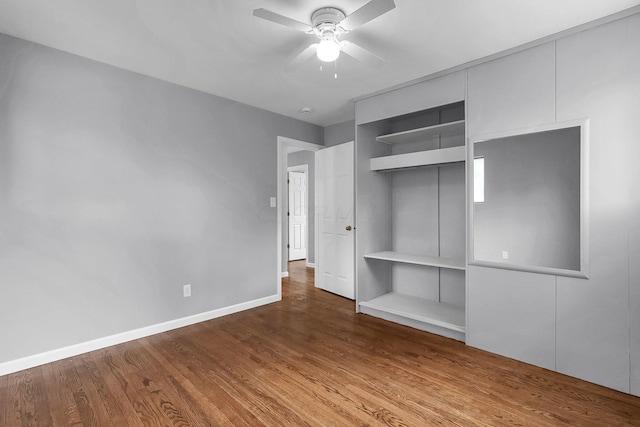 542 E Franklin St, Circleville, OH 43113 - unfurnished bedroom featuring baseboards, a ceiling fan, wood finished floors, and a closet
