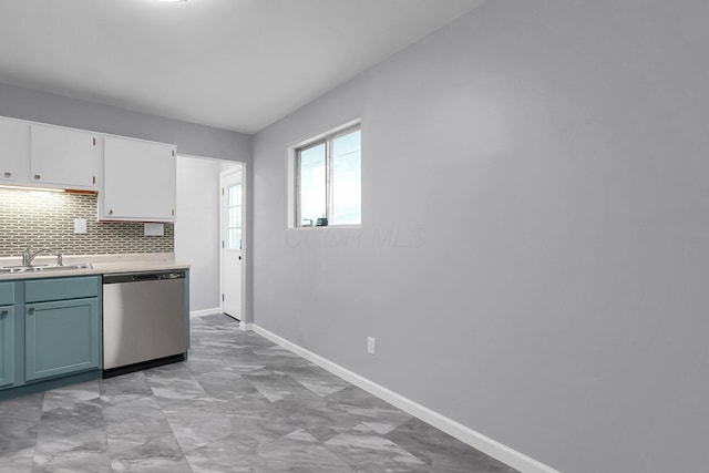 542 E Franklin St, Circleville, OH 43113 - kitchen with dishwasher, light countertops, white cabinetry, a sink, and backsplash