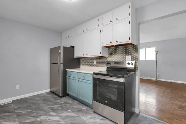 542 E Franklin St, Circleville, OH 43113 - kitchen featuring white cabinets, stainless steel appliances, tasteful backsplash, and visible vents