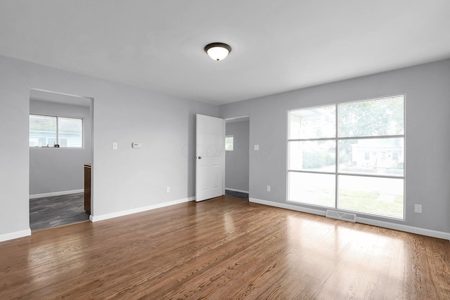 542 E Franklin St, Circleville, OH 43113 - empty room featuring baseboards, visible vents, and dark wood-type flooring