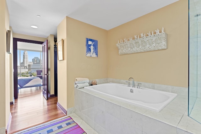 1 Miranova Pl Unit 1505, Columbus, OH 43215 - full bathroom featuring a garden tub and baseboards