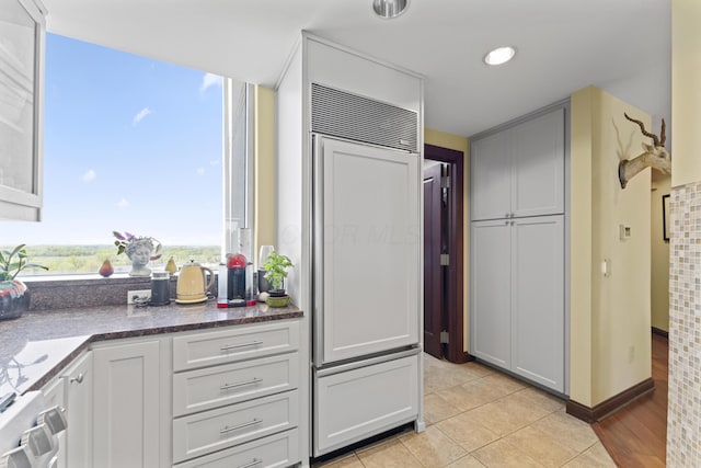 1 Miranova Pl Unit 1505, Columbus, OH 43215 - kitchen featuring paneled built in fridge, light tile patterned flooring, and dark countertops