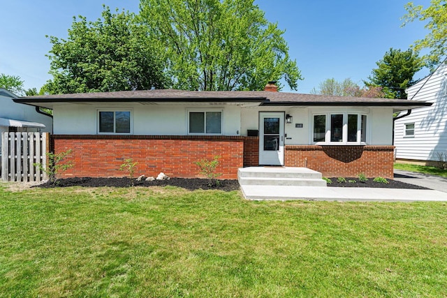 ranch-style house with stucco siding, brick siding, fence, and a front lawn