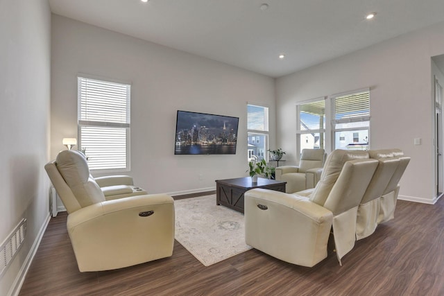 living area featuring dark wood-style flooring, baseboards, and recessed lighting