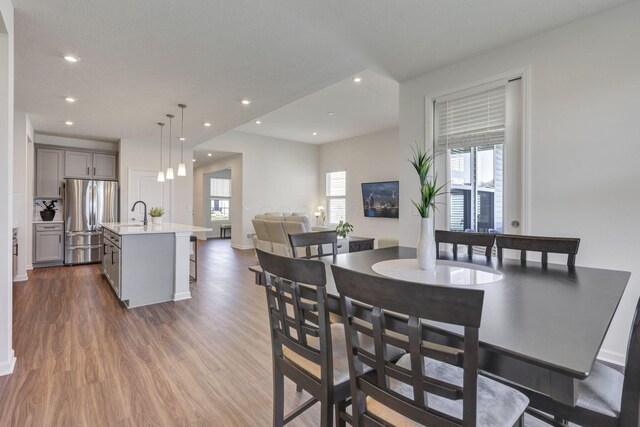dining space with recessed lighting, baseboards, dark wood-style floors, and plenty of natural light