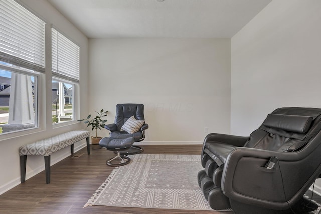 sitting room featuring baseboards and wood finished floors