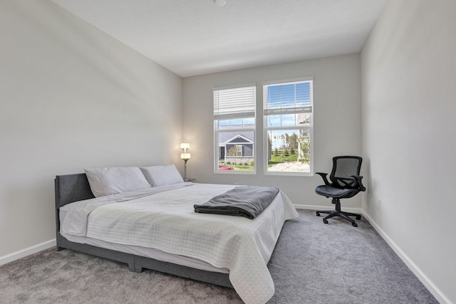 bedroom featuring baseboards and carpet flooring