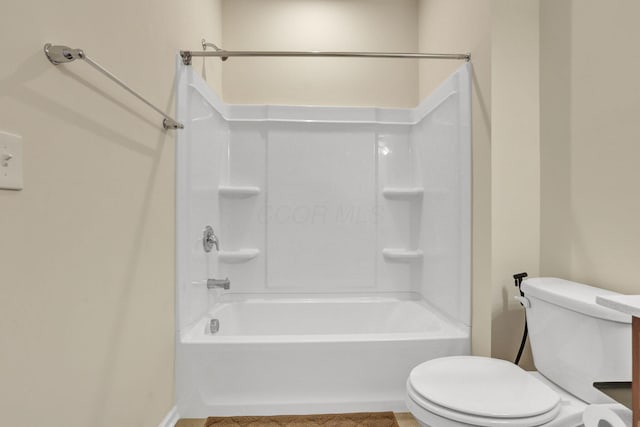 bathroom with washtub / shower combination and toilet