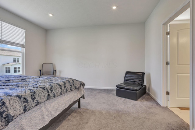 carpeted bedroom featuring baseboards and recessed lighting