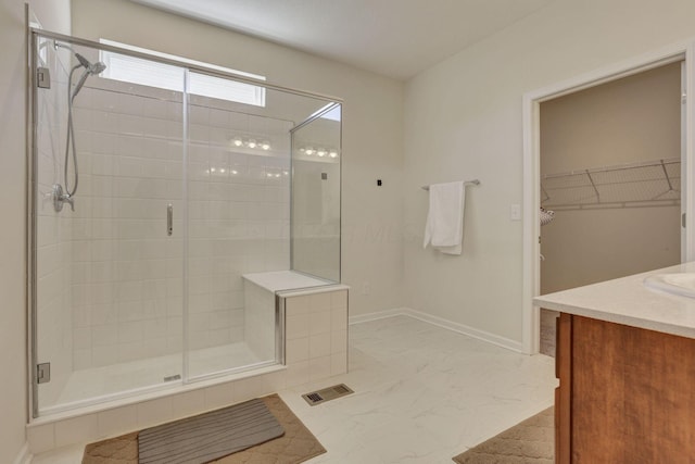 bathroom with visible vents, a stall shower, vanity, marble finish floor, and a spacious closet