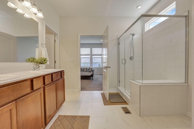 ensuite bathroom with visible vents, double vanity, a shower stall, a sink, and ensuite bath