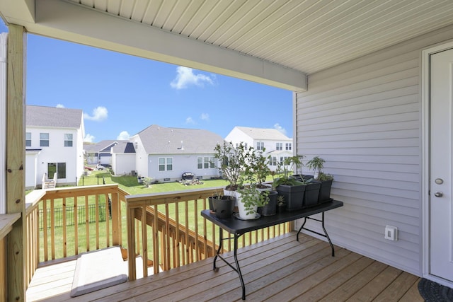 wooden deck featuring a yard and a residential view