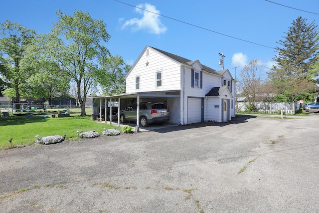 view of property exterior featuring a garage, fence, a yard, and driveway