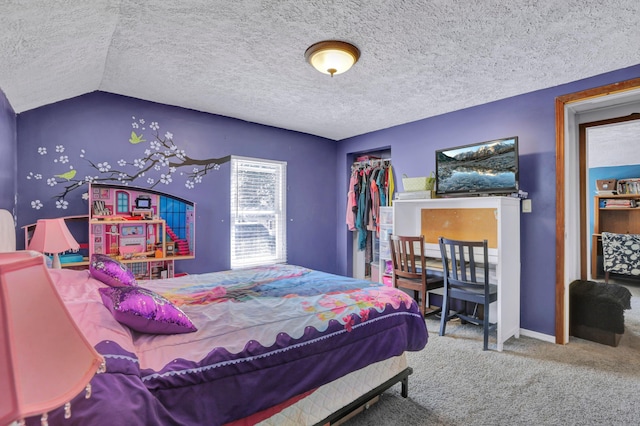 carpeted bedroom with a closet and a textured ceiling