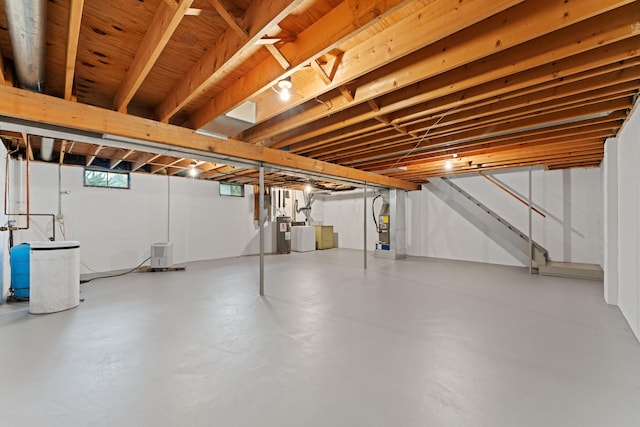 below grade area featuring water heater and stairs