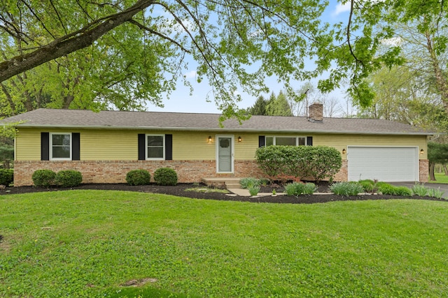 ranch-style home featuring a garage, a front yard, a chimney, brick siding, and driveway
