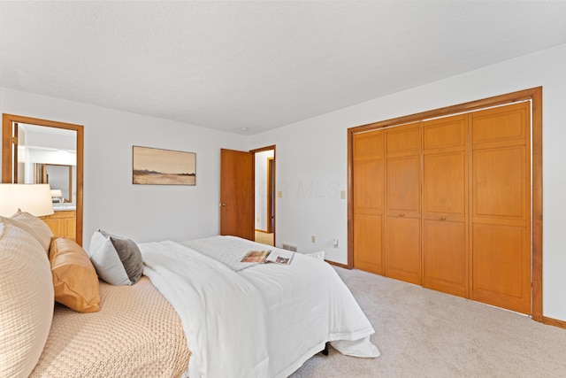 carpeted bedroom with baseboards and a closet
