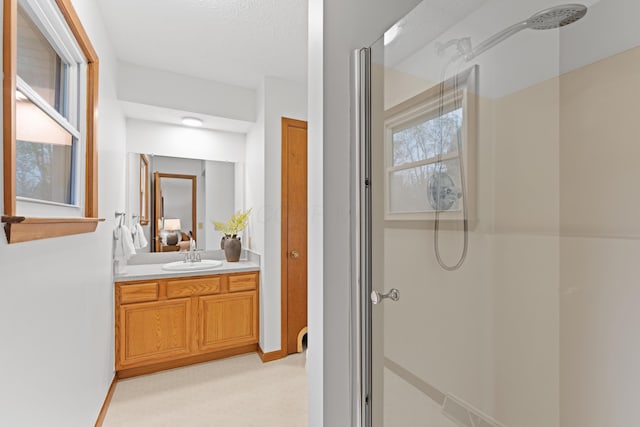 bathroom with walk in shower and vanity