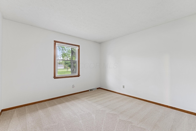 unfurnished room featuring baseboards, carpet flooring, and visible vents