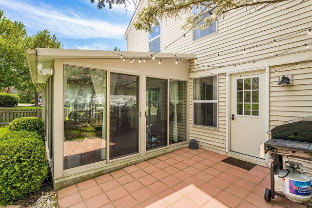 view of patio featuring fence and a grill