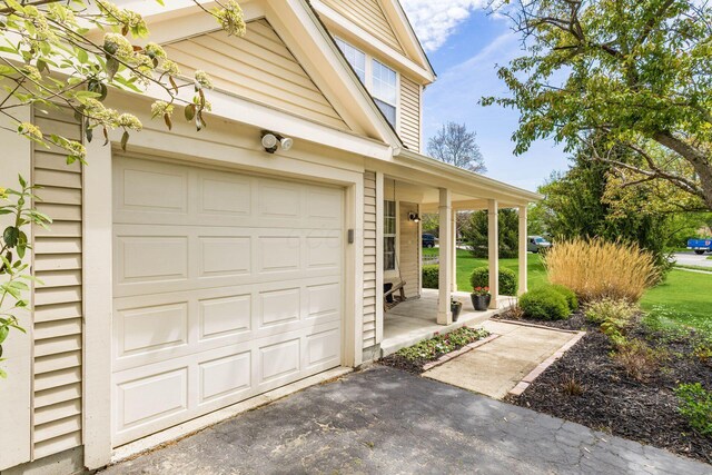 garage featuring covered porch and driveway