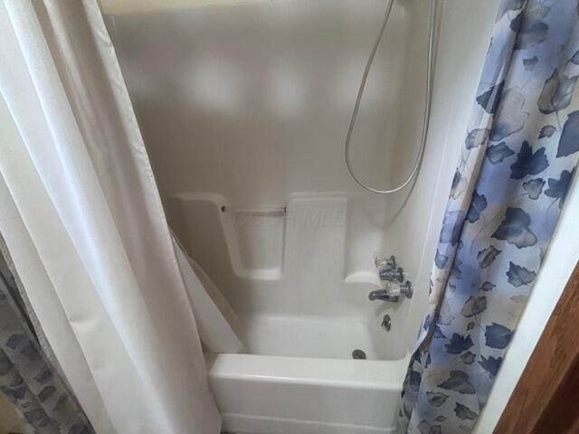 full bathroom with shower / bath combo with shower curtain