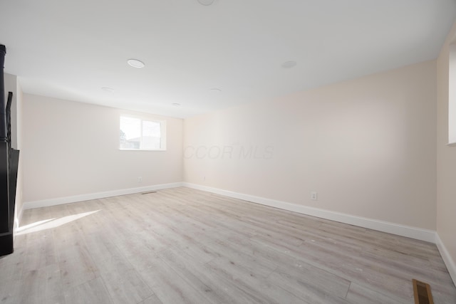 interior space featuring baseboards, visible vents, and wood finished floors