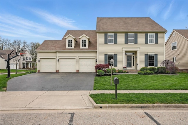 colonial house with a garage, a shingled roof, driveway, and a front lawn