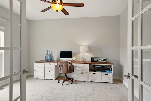 office with french doors, baseboards, light carpet, and ceiling fan