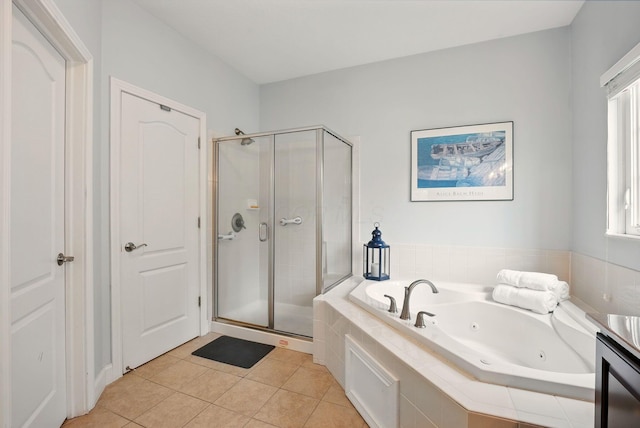 full bath featuring a tub with jets, a shower stall, and tile patterned flooring