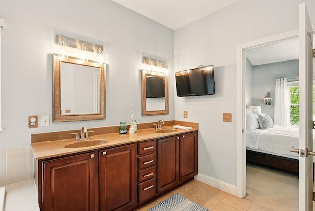 bathroom featuring double vanity, a sink, connected bathroom, and tile patterned floors