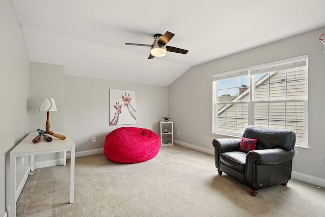 sitting room featuring baseboards, a ceiling fan, and vaulted ceiling