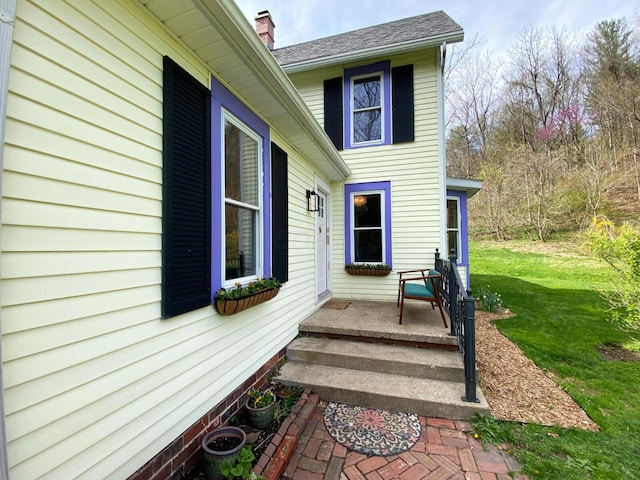 view of home's exterior featuring a yard and a chimney