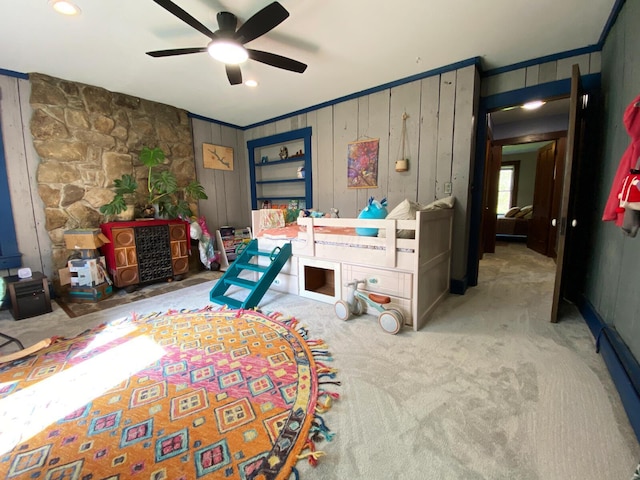 bedroom with carpet floors, a ceiling fan, and ornamental molding