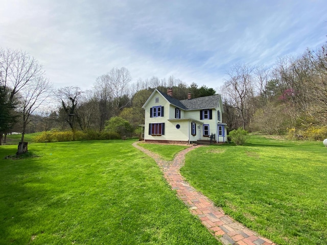 view of front of property with a chimney and a front yard