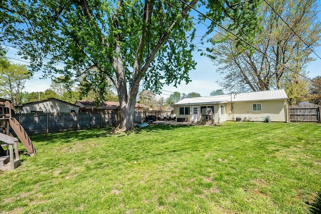 view of yard with central air condition unit and a fenced backyard
