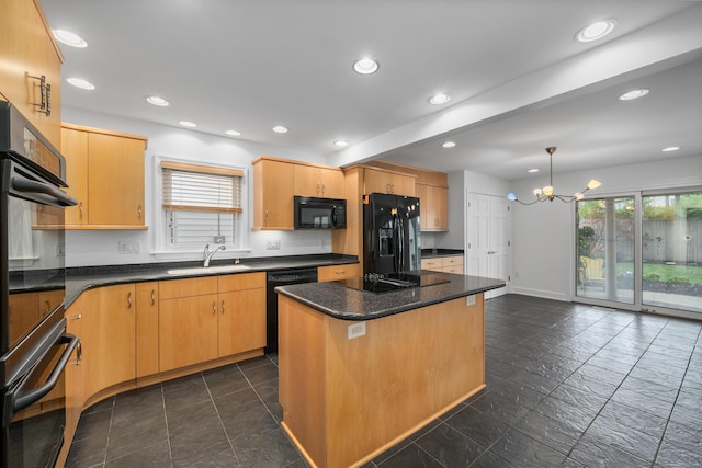 kitchen with recessed lighting, a center island, a chandelier, a sink, and black appliances
