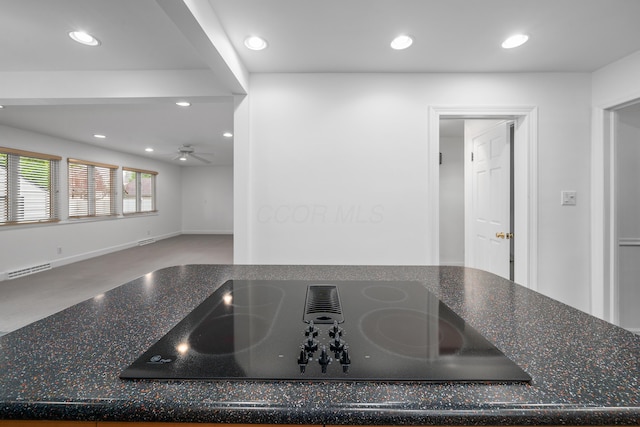 room details with black electric stovetop, dark stone counters, recessed lighting, a ceiling fan, and visible vents