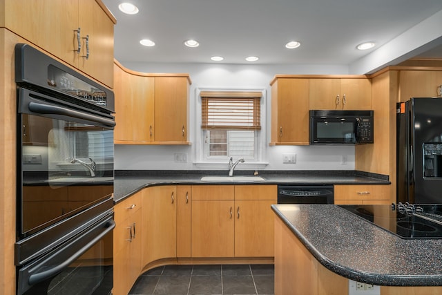 kitchen featuring recessed lighting, a sink, black appliances, and dark tile patterned flooring