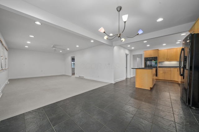 kitchen with dark countertops, black appliances, and recessed lighting