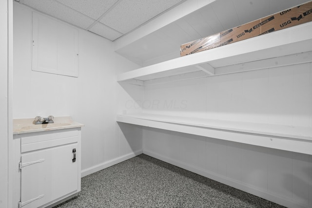 interior space featuring a paneled ceiling and a sink