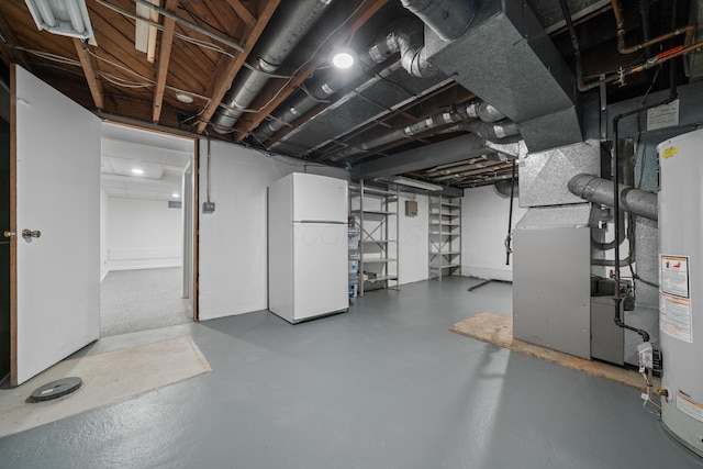 unfinished basement featuring freestanding refrigerator, heating unit, and gas water heater